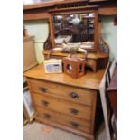 An Edwardian oak dressing chest, fitted three drawers, having bevel mirror back, 100cm wide