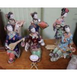 A collection of six Chinese ceramic figurines, modelled as girls in polychrome painted costume and a