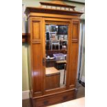 An Edwardian oak single mirror door wardrobe, drawer to base, 108cm wide