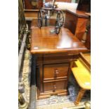 A pair of modern dark wood small bedside cabinets