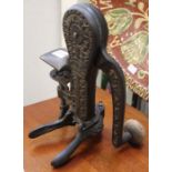 An early 20th century worktop cast iron bottle opener