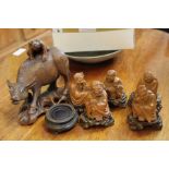 A selection of wooden carvings the majority oriental
