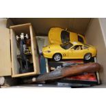 A box containing cars, microscope, camera, gun, iPad etc