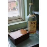 A Bells old scotch whisky eight pint empty bottle with a Victorian rosewood box