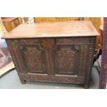 An early 19th century small sized box coffer with plain lid and later carving to front