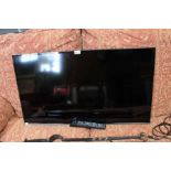 A Samsung 38" flat screen television with no stand or bracket