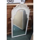 An ornate cream framed bevel plate mirror