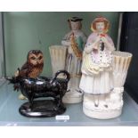 A Royal Doulton Scotch Whisky owl decanter, a Jackfield cow creamer jug and a pair of figures