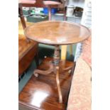 A circular topped wine table