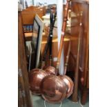 Four 19th century copper headed warming pans with a coaching horn