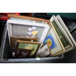 A crate containing a selection of pictures and prints
