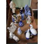 A selection of porcelain figurines both human and avian, including a Georgian snuff taking toby