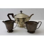 Adie Brothers, a three-piece silver tea set comprising; teapot, sugar, and milk jug, Birmingham 1931