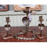 A pair of Indian brass Cobra form candle holders, 14cm high and a single larger one, 21cm high