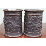 A pair of Oriental cast brass brush pots decorated with dragons 10.5cm high