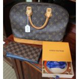 A Louis Vuitton bag with shoulder strap and wallet