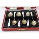 A cased set of six silver gilt and white enamel coffee spoons, the reverse of each bowl floral decor