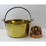 A brass maslin pan and a late 19th copper jelly mould