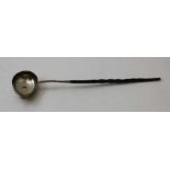 A George III silver ladle, with pouring lip, inset gold coin, dated 1786, fitted twisted whale bone