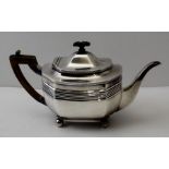 Thomas Bradbury and Sons, a Georgian design silver tea pot, raised on four ball feet, Sheffield 1901