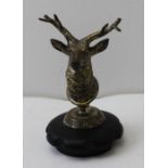 An early to mid 20th century stag head car radiator mascot, inscribed "HCA & AC", 12cm high