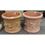 A pair of small ornate terracotta plant pots