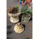 Two stone garden planters with with non-matching base