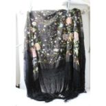 A late 19th century shawl, the black ground embroidered all over with flowers in multi-colours, with