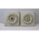 Two marble and alabaster floral rosettes, the bases 20cm square