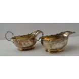 Adie Brothers, a pair of Georgian design silver sauceboats, having fancy rim and "C" scroll handles,
