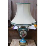 A pair of continental hand painted porcelain table lamps on cast brass plinth with contrasting