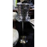 A chromed ice bucket and stand