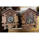 Two small wooden cuckoo clocks with accessories