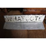 A "Whatcote" village name sign and another "Whatcote" aluminium sign