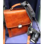A leather "Man" bag and a "Nikon Coolpix L830" camera
