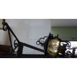 A vintage wrought iron hanging lantern with original corner bracket