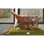 A wooden model of a horse drawn cart