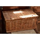 A wicker picnic hamper containing a quantity of brassware and cast metal dog nutcracker