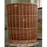 A tall wicker laundry basket