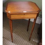 A 19th century satinwood ladies writing table, cantered top. pens to reveal writing surface and comp