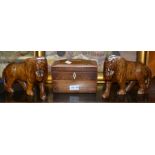 A pair of carved oak lions and a 19th century mahogany and satin wood inlaid tea caddy