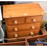 A small modern pine two short over two long chest of drawers