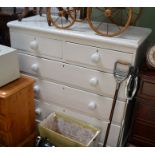 A white painted chest of drawers, two short over three long drawers