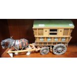 A porcelain model of a shire horse affront a scratch built gypsy wagon