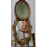 Two gilt oval mirrors