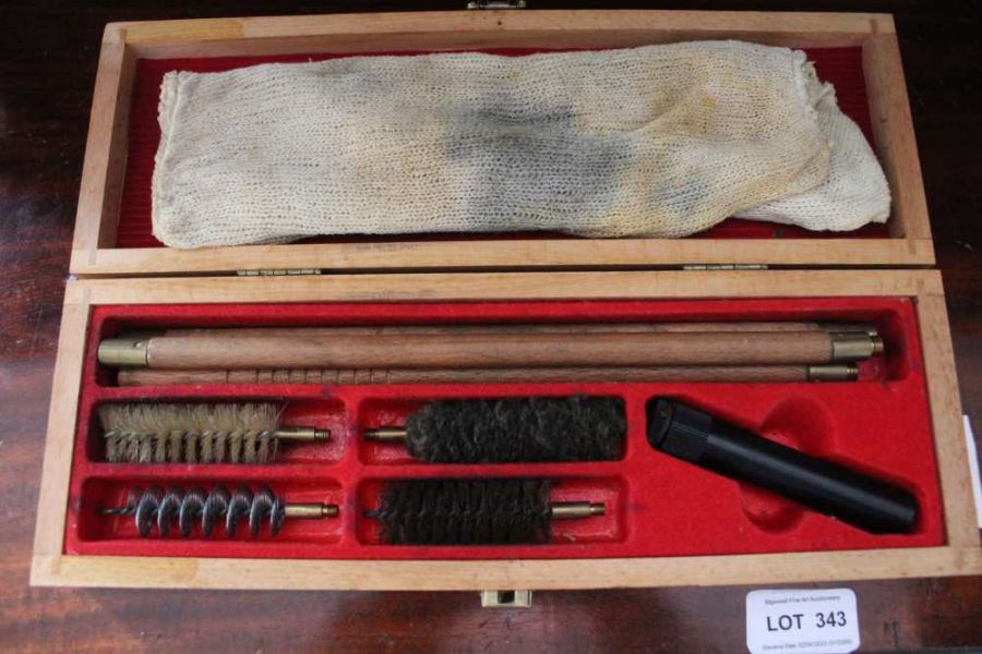 A boxed gun cleaning rod and brushes