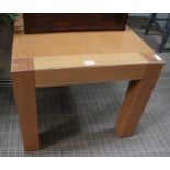 An oak square coffee table on substantial plain blocked legs