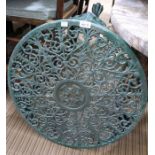 A cast metal circular low garden table