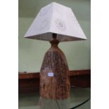 A rough natural wood based table lamp