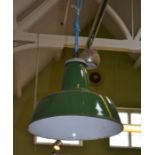 A pair of green and white enamel industrial light shades